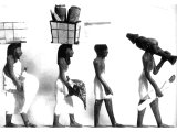 Worshippers carrying offerings of linen, food and carving to be offered in a temple.
